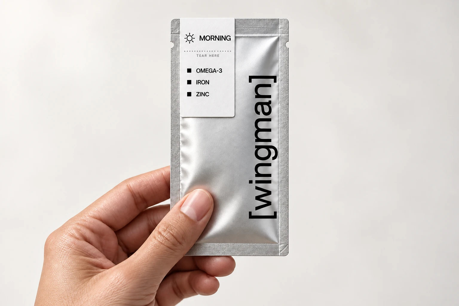A Wingman sachet held in hand